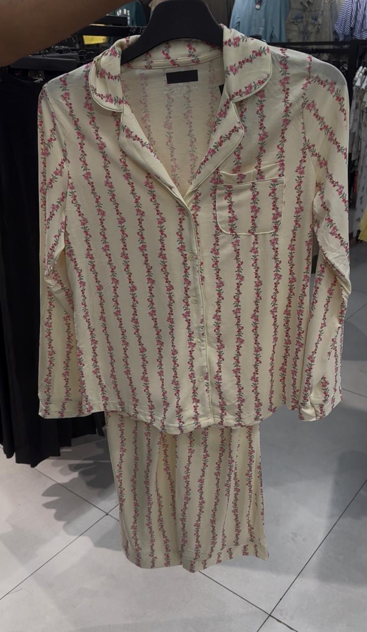 Historical third-party reference: cream floral shirt and matching trousers on a hanger